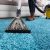 person_using_an_at_home_carpet_cleaner